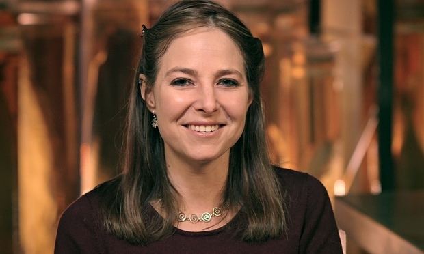 Smiling Alice Roberts wearing sleeve and a necklace