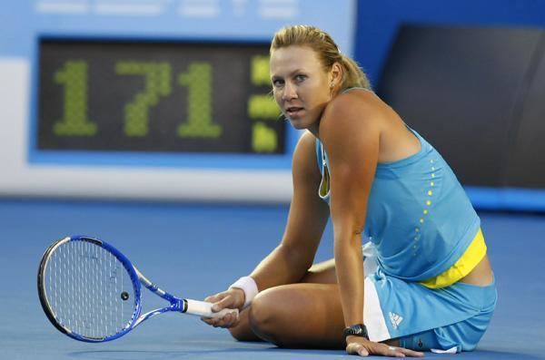 Alicia Molik sitting on the floor while wearing a blue top paired with a blue skirt