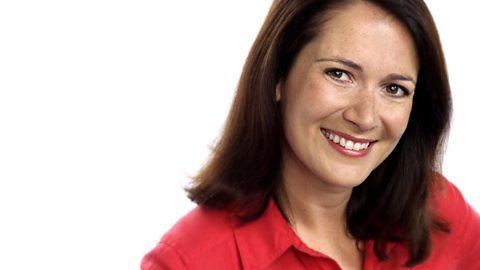 Alina Jenkins smiling, with shoulder-length hair, and wearing a red polo shirt.