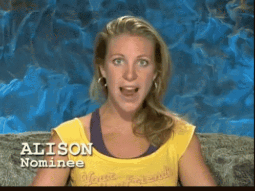 GIF of Alison Irwin while talking and wearing yellow blouse and violet inner top