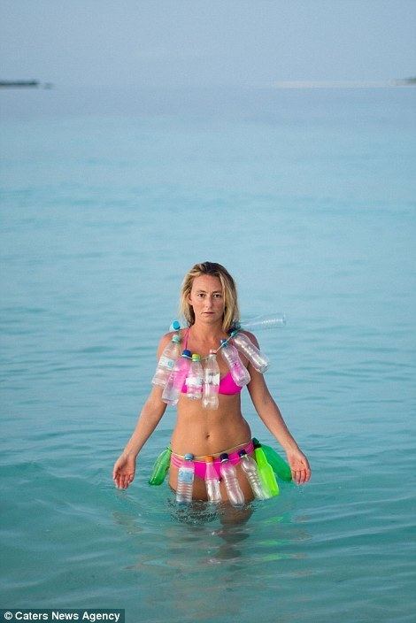 Alison Teal wearing dozens of plastics on her body while being on water