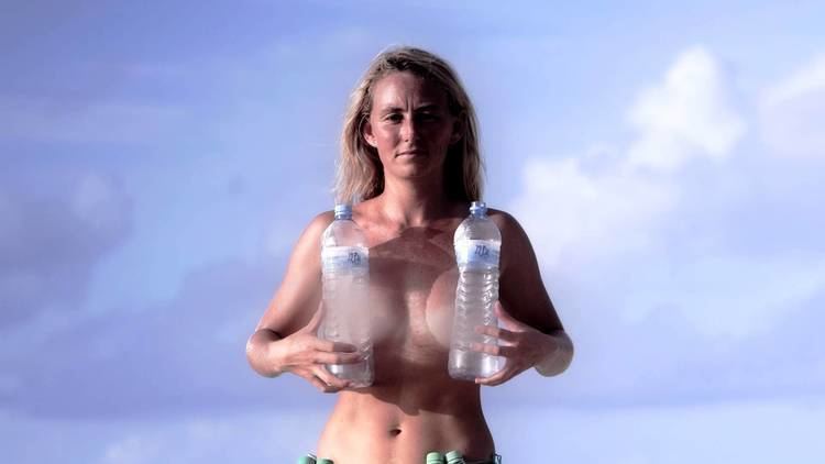 Alison Teal being topless holding a two plastic bottles in Alison's Adventures
