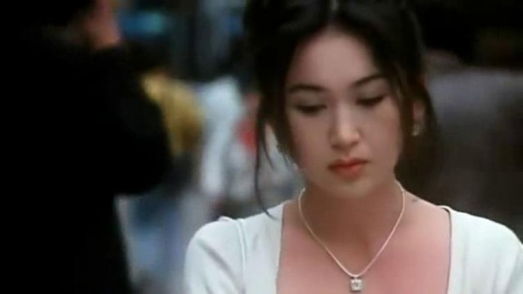 Irene Wan wearing a white blouse and necklace in a movie scene from All of a Sudden (1996)