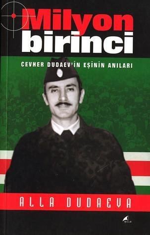 The "Milyon Birinci", a book by Alla Dudayeva featuring Dzhokhar Dudayev with a serious face, wearing a black army cap, a black army fatigue uniform over white long sleeves, and a black necktie.