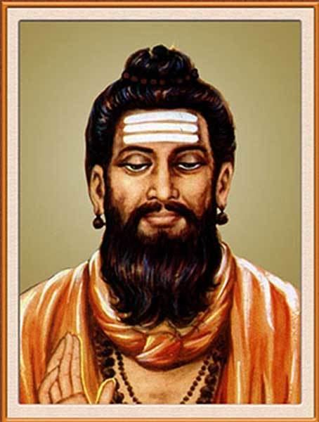 Portrait of Allama Prabhu with mustache and beard while wearing an orange long sleeve, necklace, and bracelet