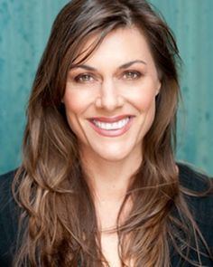 Ally Fowler smiling while wearing a black blouse