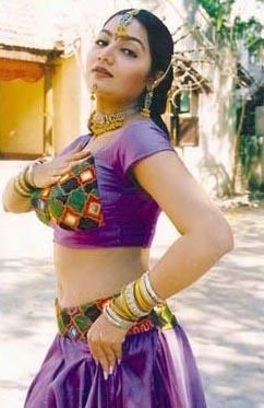 Alphonsa (actress) wearing purple two-piece clothes, bracelets, a necklace, and earrings