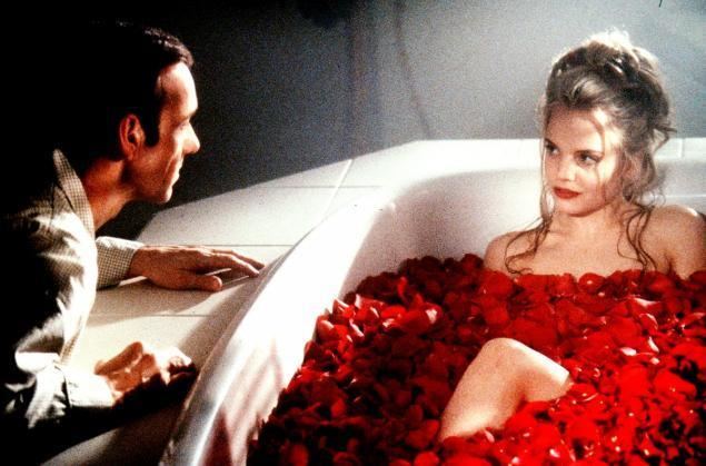 American Beauty (1999 film) movie scenes  peers in to the eyes of actress Mena Suvari while she sits in a bath tub filled with rose petals in a scene from Dreamworks 1999 film American Beauty 