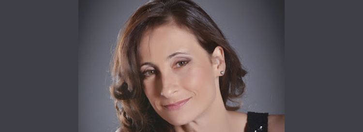 Amparo Noguera wearing a black top and earrings.