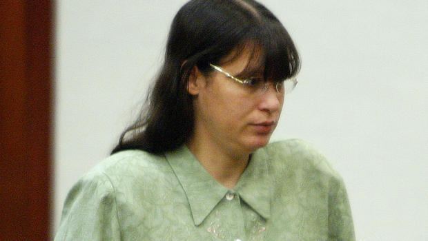 Andrea Yates wearing a green blouse and eyeglasses