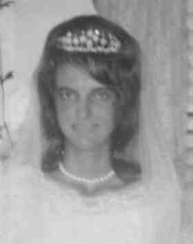Welma Rose Albury smiling while wearing a crown and wedding dress