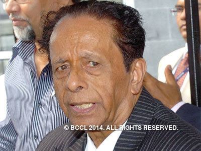 Anerood Jugnauth in his black and gray striped coat and white long sleeves
