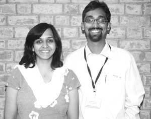 Ankita Diwekar Kabra smiling together with his husband Vardan Kabra wearing eyeglasses and white long sleeves.