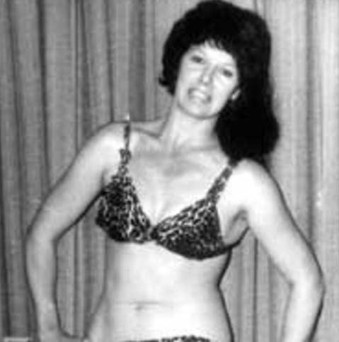 Ann Casey posing before a match and wearing her trademark spotted panther sports bra.