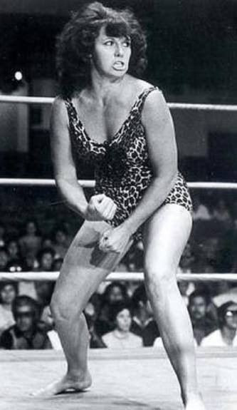 Ann Casey in the middle of a wrestling match wearing her trademark spotted panther wrestling suit.