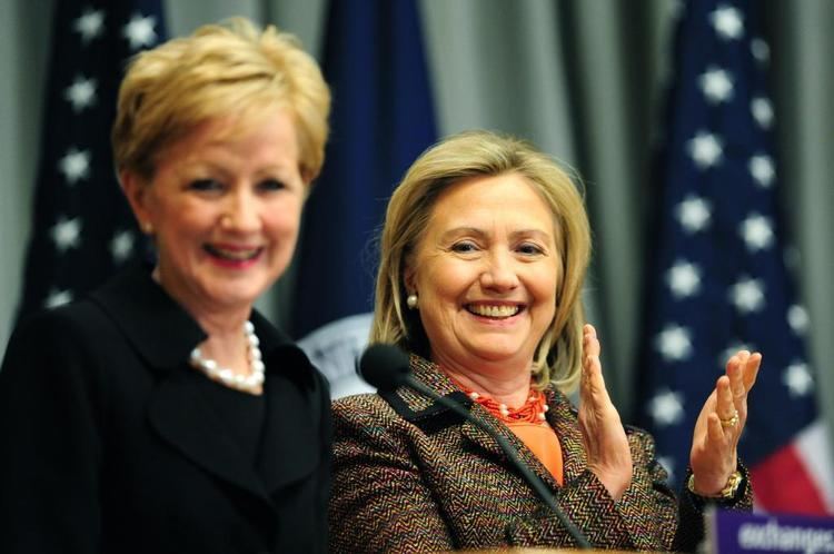 Ann Stock Secretary of State Hillary Clinton applauds alongside Ann Stock
