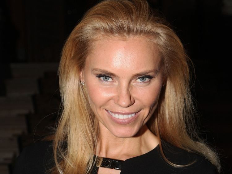 Anna Anka smiling while wearing a black blouse