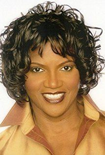 Anna Maria Horsford smiling while wearing a brown blouse