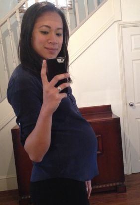 Anne Keothavong mirror shot while being pregnant and wearing a blue blouse and black pants