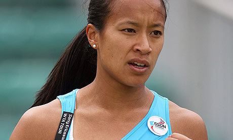 Anne Keothavong wearing blue tank top, badge pin, and earrings