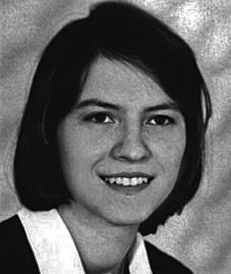 Anneliese Michel smiling with a shoulder-length hair while wearing a blouse with a collar