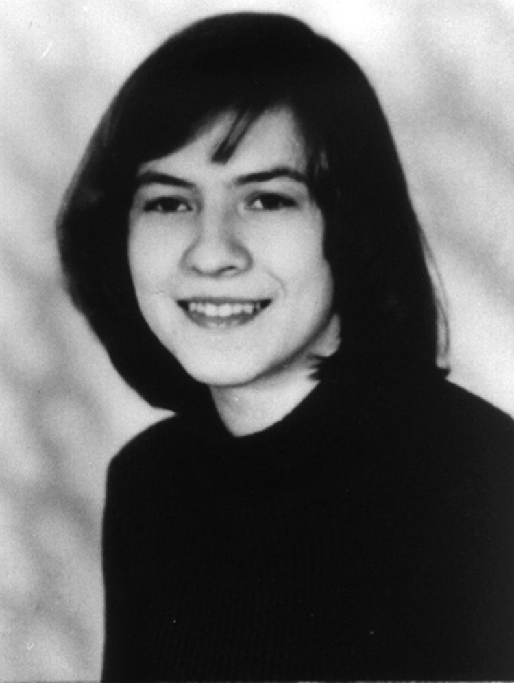Anneliese Michel smiling with a shoulder-length hair with bangs while wearing a blouse