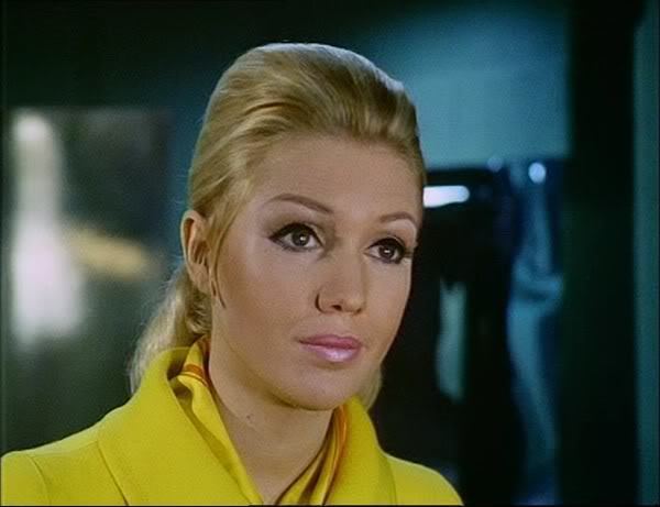 Annette Andre wearing a yellow blouse and light pink lipstick