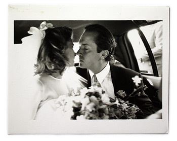 Carole Radziwill and Anthony Stanislas Radziwill kissing each other inside the car on their wedding day