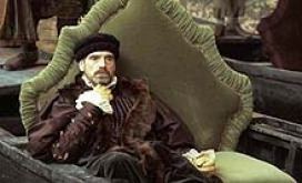 Jeremy Irons as Antonio sitting on a couch in a scene from the 2004 romantic drama film, The Merchant of Venice