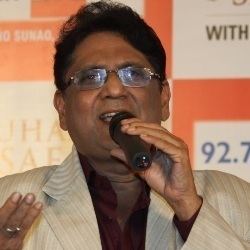 Anwar (singer) while singing wearing a shirt and a brown coat