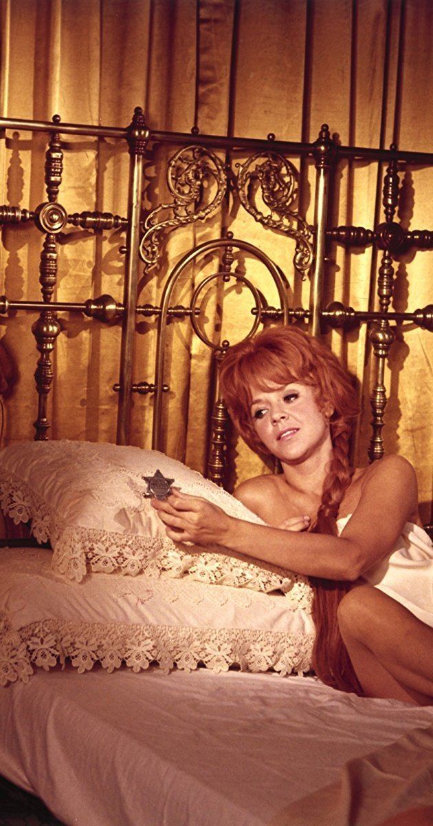 Arlene Golonka in a luxurious bed as Jennifer in Hang 'Em High