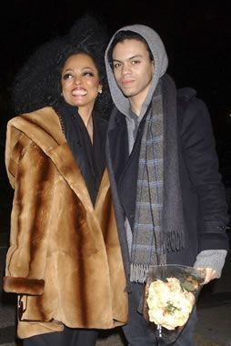Diana ross smiling and wearing a brown coat and black blouse while Evan Ross wearing a black coat, gray jacket and scarf