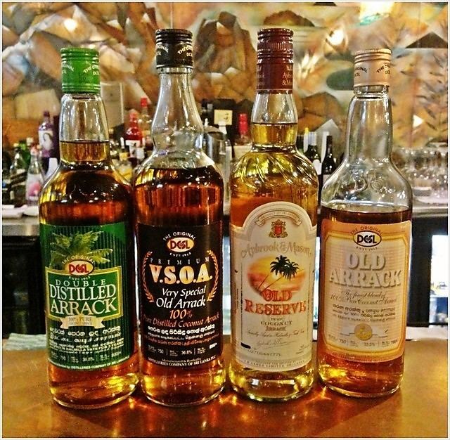 Bottles of different brands of Arrack displayed in a bar.