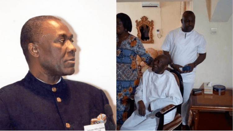 On the left, Arthur Nzeribe with a serious face while looking at something and wearing a black coat with an ID over a white shirt.On the right, Arthur Nzeribe with a serious face while looking at something and sitting on a chair with a man and woman at his back. Arthur is wearing a white jalabiya.