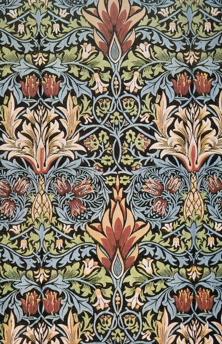 A piece is known as Snake in heeled textiles by William Morris, an elegant swirl of vines in azurish blue, flowers in the middle, a dark red-orange with white orange tips, the small flowers in dark red-orange, and long strokes of leaves dark cyanish blue-white color, a bud and vine of green yellowish white leaves, and a blooming flower in dark orange color and white orange yellow tip.