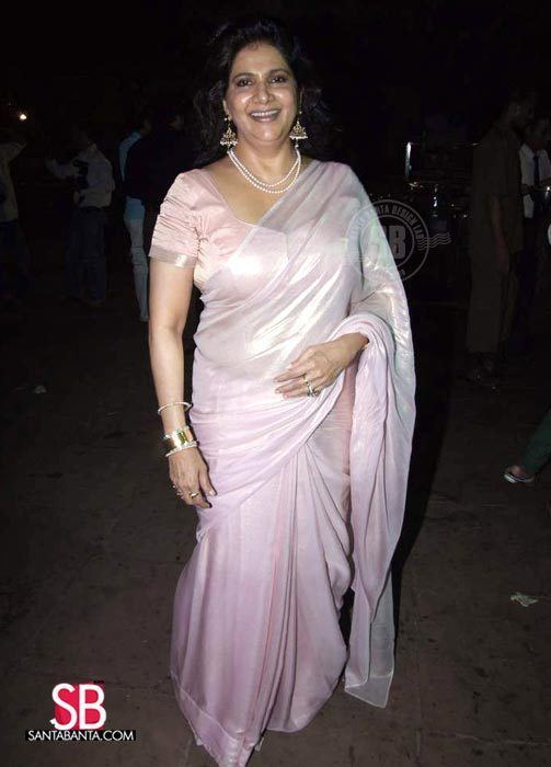 Asha Sachdev smiling while wearing a light pink dress and pieces of jewelry