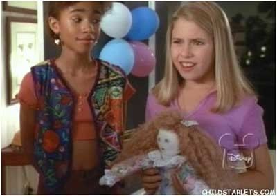 Young Ashleigh Sterling holding a doll