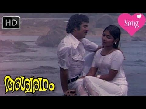 Srividya bathing in the rain while wearing a white dress and Raveendran wearing white long sleeves in the music video of the 1980 film, Ashwaradham