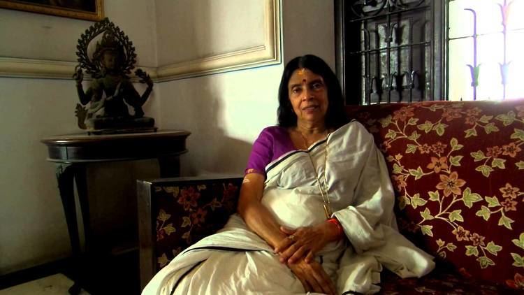 Aswathi Thirunal Gowri Lakshmi Bayi sitting on the couch while wearing a violet and white dress
