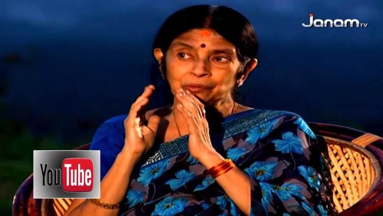 Aswathi Thirunal Gowri Lakshmi Bayi speaking while sitting on the chair and wearing a blue dress