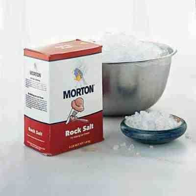 A box of Morton rock salt, a large stainless bowl, and a blue-green small bowl containing a salt