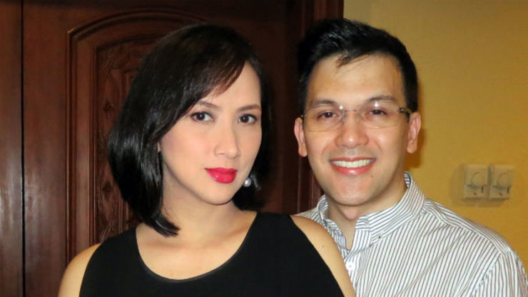 Ayen Munji-Laurel with a tight-lipped smile and wearing a black blouse  while Franco Laurel wearing eyeglasses and white striped long sleeves