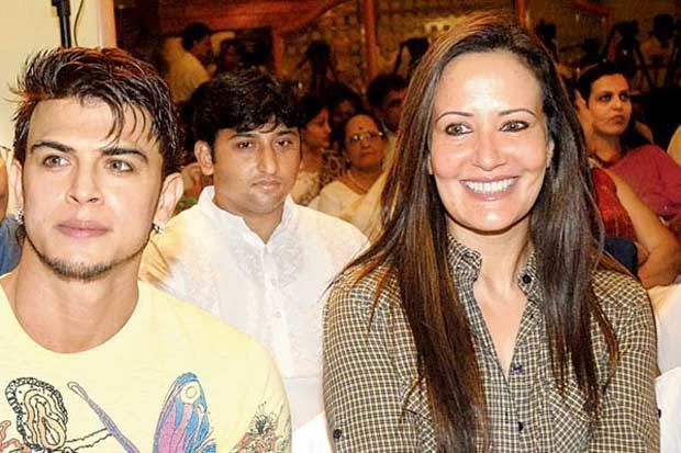 Sahil Khan wearing yellow printed shirt and Ayesha Dutt wearing brown and white long sleeves while smiling