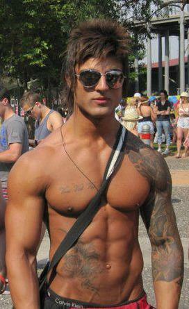 Aziz Shavershian is topless and wearing sunglasses.