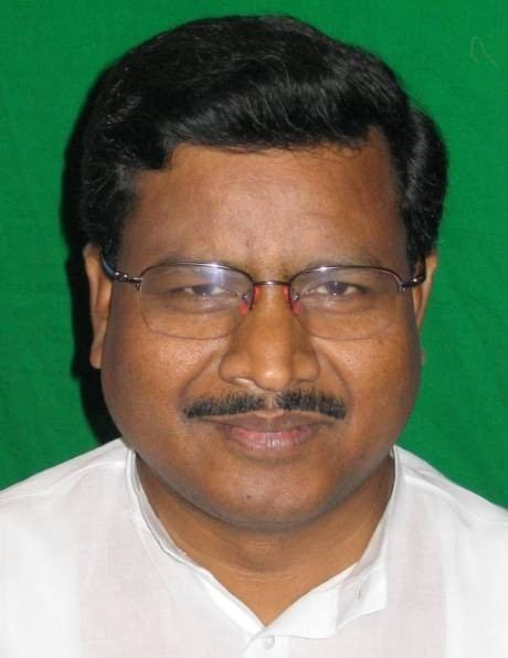 Babulal Marandi, Former Chief Minister of Jharkhand is smiling and has black hair, and a mustache, he is wearing eyeglasses and a white top.