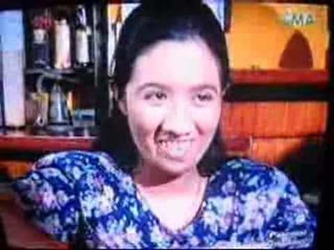Sunshine Dizon as Bakekang, smiling and wearing a white and blue shirt in a drama scene from a Philippine drama called "Bakekang" that aired on GMA Network from September 11, 2006, and ended on March 30, 2007.