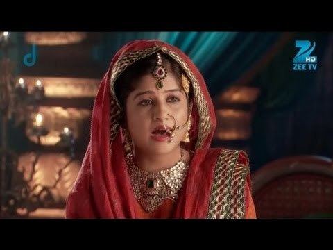 Sonakshi More as Bakshi Banu Begum, wearing a red veil, dress, maang tikka, and jewelry in the 2013 Indian fictional drama romantic tv series, Jodha Akbar
