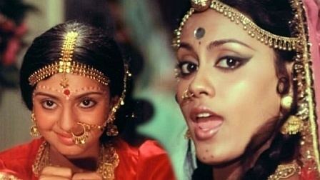 Rajni Sharma smiling while wearing a gold headdress and red dress