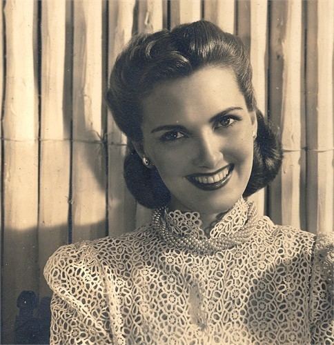 Barbara Daly Baekeland smiling and wearing a lace dress