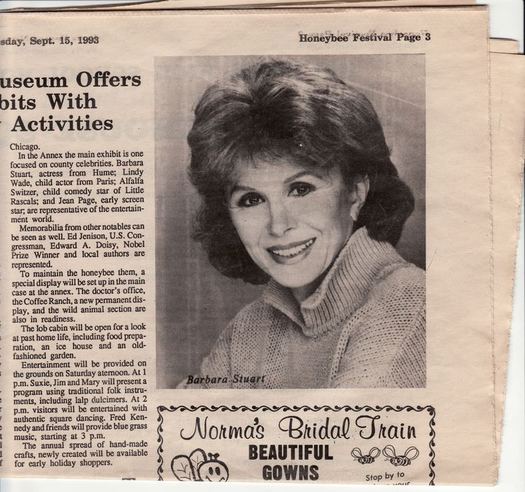 Portrait of Barbara Stuart smiling while wearing a white knitted blouse featured on a newspaper